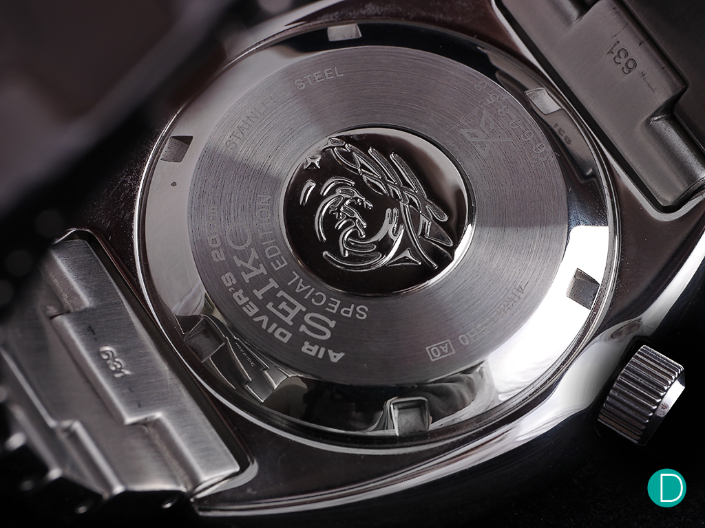 The caseback, showing the PADI markings and the "Project Aware" engraving. 