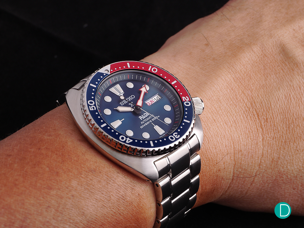 On the wrist, the 45mm case feels rather comfortable. Perhaps due to the curves on the case as well as the smooth matt finish. But the heft tells the wearer that it is a tough and robust watch ready for almost anything. And well adapted for diving as well as being a part of a casual wardrobe.